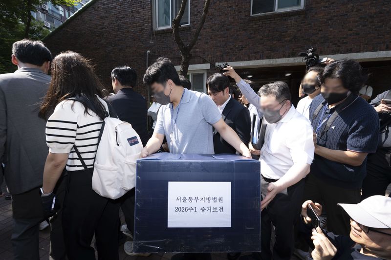 [서울=뉴시스] 황준선 기자 = 김지연 서울동부지방법원 부장판사와 관계자들이 10일 오후 6·3 지방선거 투표용지 부족 사태가 발생한 잠실7동 제2투표소였던 서울 송파구 우성아파트 노인정의 현장 검증을 마친 뒤 증거물을 들고 현장을 나서고 있다. (공동취재) 2026.06.13. photo@newsis.com