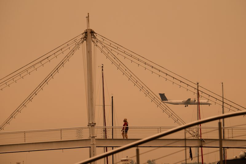 A plane lands at Billy Bishop Toronto City Airport as wildfire smoke fills Toronto, on Wednesday, July 15, 2026. (Laura Proctor/The Canadian Press via AP)