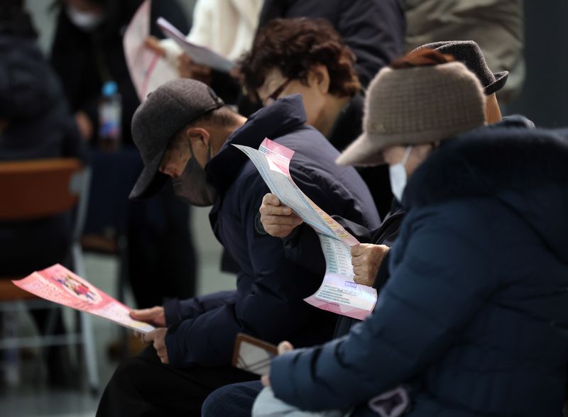 [서울=뉴시스] 지난해 12월 10일 마포구 노인일자리 박람회가 열린 서울 마포구청에서 구직자들이 팜플렛을 살피고 있는 모습. (사진=뉴시스 DB) 2025.12.10. photo@newsis.com