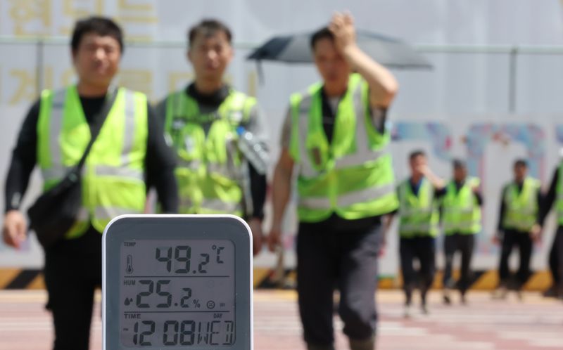 펄펄 끓는 공사현장 서울 전역에 '폭염중대경보'가 발효된 5일 서울 강남구의 한 공사현장 부근 횡단보도에서 공사 관계자들이 이동하고 있다. 연합뉴스