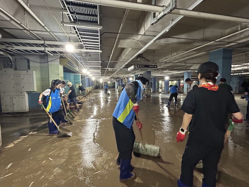 지난 29일 경남 거제시 양정동 수월힐스테이트에서 진행된 '거제 집중호우 피해지역 복구 봉사활동' 현장에서 신한은행 임직원들이 봉사활동을 하고 있다. 신한은행 제공