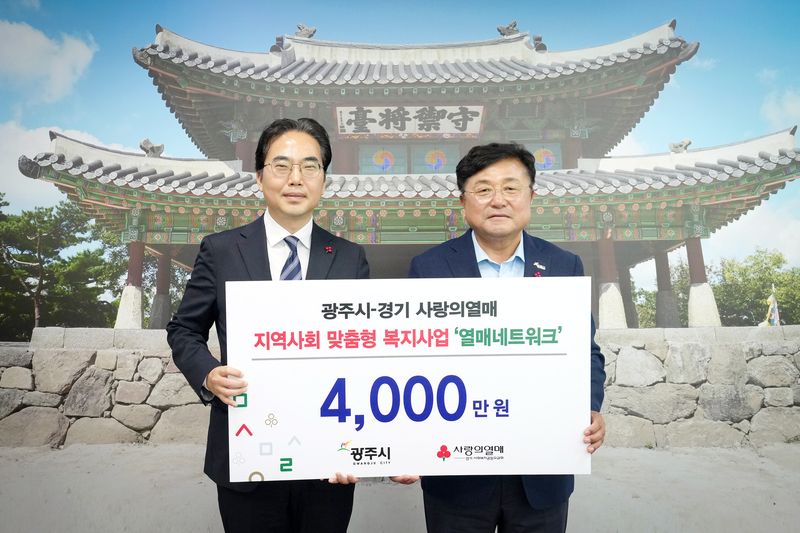 김효진 경기 사랑의열매 사무처장(왼쪽)이 박관열 광주시장에게 '열매 네트워크' 사업비를 전달하고 있는 모습.(광주시 제공)