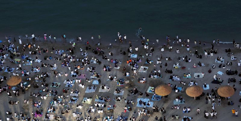 [부산=뉴시스] 하경민 기자 = 본격적인 피서철이자 밤낮으로 푹푹 찌는 더위가 이어진 25일 밤 부산 수영구 광안리해수욕장에서 시민과 관광객들이 더위를 식히고 있다. 부산에는 지난 18일부터 폭염특보가 발효 중이며, 19일부터 열대야 현상이 이어지고 있다. 2026.07.26. yulnetphoto@newsis.com