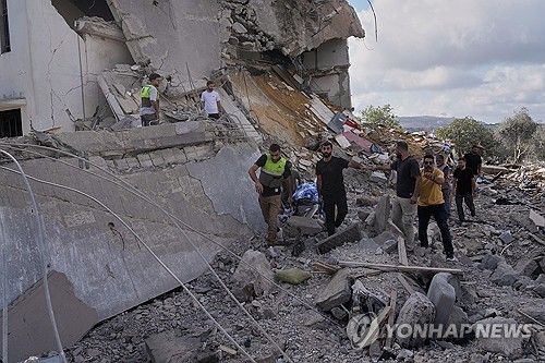 이스라엘군의 공습을 받은 레바논 남부 마을에서 사망자 시신을 수습하는 사람들 (출처=연합뉴스)