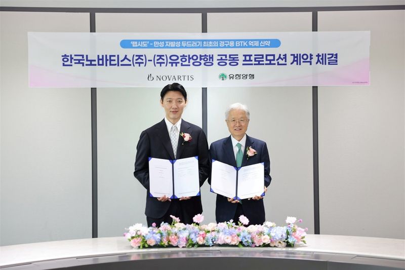 한국노바티스 유병재 대표이사(왼쪽)와 유한양행 조욱제 대표이사가 지난 3일 지난 3일 유한양행의 랩시도 국내 개원가 프로모션에 대한 계약을 체결하고 기념촬영을 하고 있다. 유한양행 제공