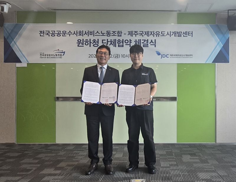 송석언 제주국제자유도시개발센터(JDC) 이사장(왼쪽)과 김동구 전국공공운수사회서비스노동조합 제주지부 제이디씨파트너스지회장이 2일 JDC 본사에서 원하청 단체협약을 체결한 뒤 협약서를 들어 보이고 있다. 노사는 공공부문 도급 노동자 보호지침 이행과 노동안전보건협의체 강화, 노사 소통기구 마련 등에 합의했다. 사진=JDC