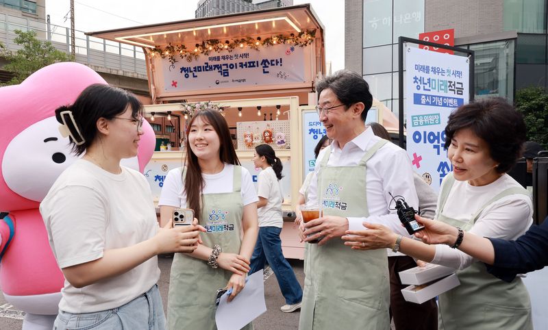이억원 금융위원장이 '청년미래적금' 가입 신청이 시작된 6월 22일 서울 성동구 신한빌딩 인근에서 출근길 청년들에게 청년미래적금을 홍보하고 있다. 2026.6.22 ⓒ 뉴스1 이호윤 기자