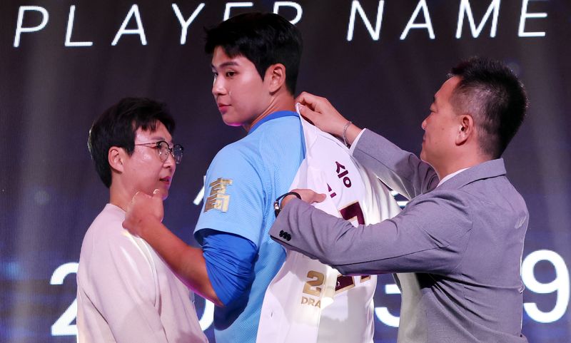 지난달 21일 서울 송파구 롯데호텔 월드 크리스탈볼룸에서 열린 2027 KBO 신인 드래프트. 전체 1순위 지명권을 보유한 키움히어로즈 허승필 단장(오른쪽)이 하현승(부산고)을 지명한 후 유니폼을 입혀주고 있다. 뉴시스
