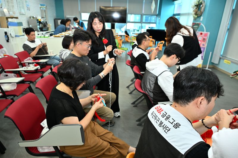 지난 17일 가을철 지역 일손돕기에 나선 BNK부산은행(은행장 김성주) 봉사단이 부산 영도구에서 가로수 월동과 거리 경관 개선을 위한 '그래피팅 니팅' 뜨개옷을 제작하고 있다. BNK부산은행 제공