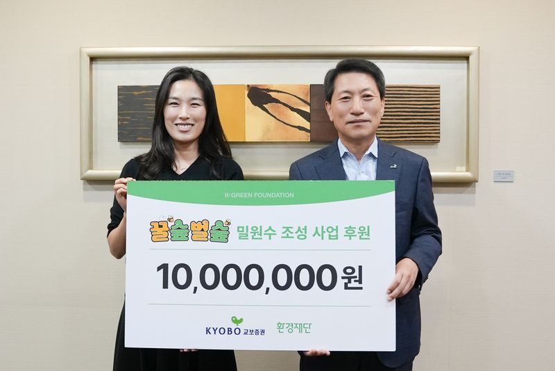 박봉권 교보증권 대표이사(오른쪽)와 박기영 환경재단 국장이 지난 20일 드림이 그린레이스 캠페인 기부금 전달식에서 기념사진을 촬영하고 있다. 교보증권