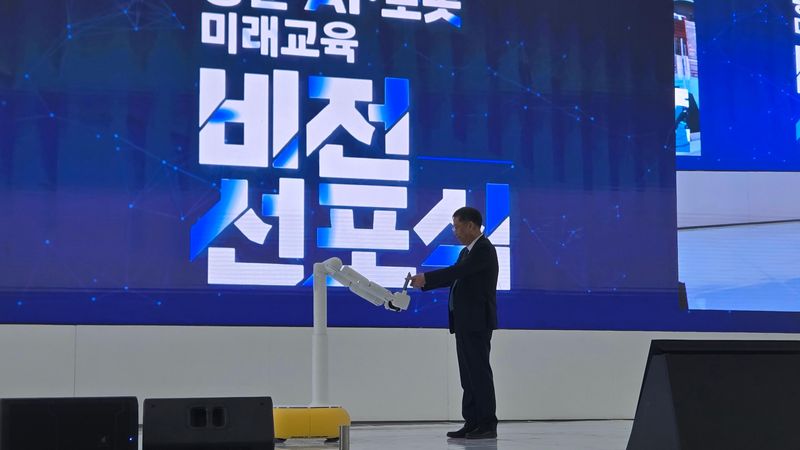 윤도영 광운대 총장이 29일 서울 노원구 광운스퀘어 원형 광장에서 열린 '광운 AI·로봇 미래교육 비전' 선포식에서 양팔 로봇 '듀스(DEUX)'로부터 비전 선포문을 전달받고 있다. 사진=김만기 기자